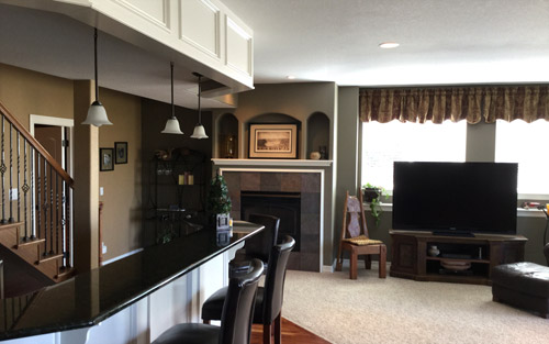Basement remodel with second kitchen, bar with granite countertops custom cabinetry, fireplace and windows by Mountain View Corporation in Boulder Colorado