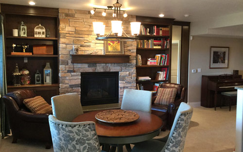 Basement remodel with stone filreplace and custom built wood cabinets, new carpet flooring and windows by Mountain View Corporation in Littleton Colorado