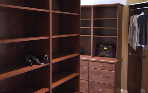 Closet remodel with custom build cherry wood cabinets for clothing and shoe storage and organization by Mountain View Corporation in Broomfield Colorado 