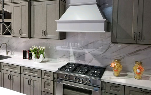 Stone arch doorway with iron gate for custom built wine cellar by Mountain View Corporation in Glendale Colorado