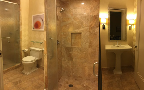 Warm and inviting modern remodeled bath with tiled shower, and pedastool sink by Mountain View Corporation in Lonetree Colorado