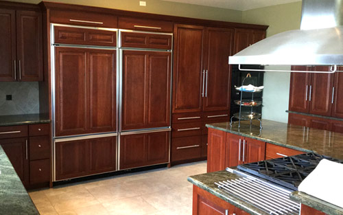 Modern kitchen remodel with cherry wood cabinets, matching appliances and granite countertops by Mountain View Corporation in Brighton Colorado