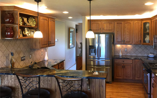 Kitchen remodel with marble countertops and refinished wood cabinets, stainless steel appliances and hardwood floors by Mountain View Corporation in Thornton Colorado