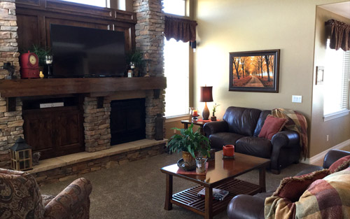 Modern living room remodel with stone fireplace, new carpet, paint and windows by Mountain View Corporation in Colorado
