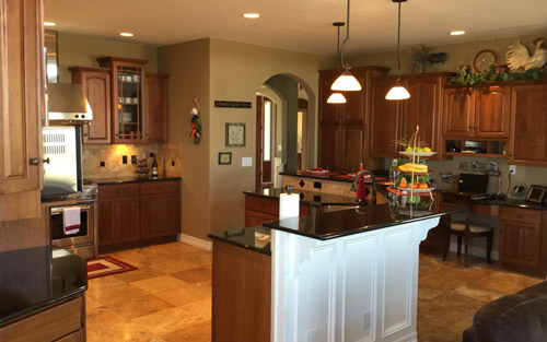 Newly remodeled home kitchen with custom cabinets, island sink and granite countertops by Mountain View Corp Colorado