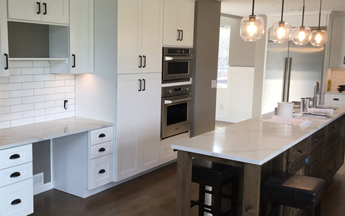 Goregous modern kitchen in white with quartz marble countertops, subway tile back splash and custom cabinets by Mountain View Corporation in Golden Colorado